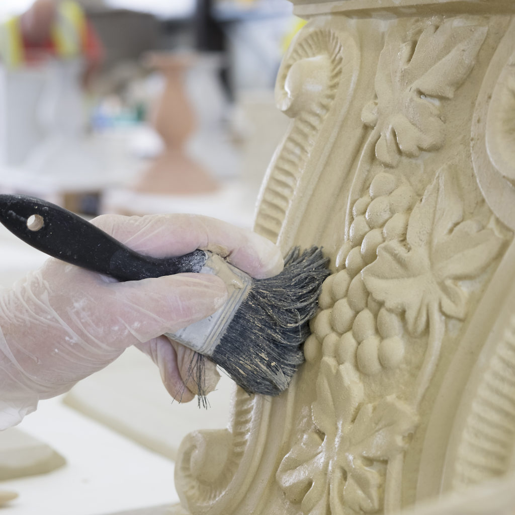 A Haddonstone colleague cleans a cast stone design in the factory.